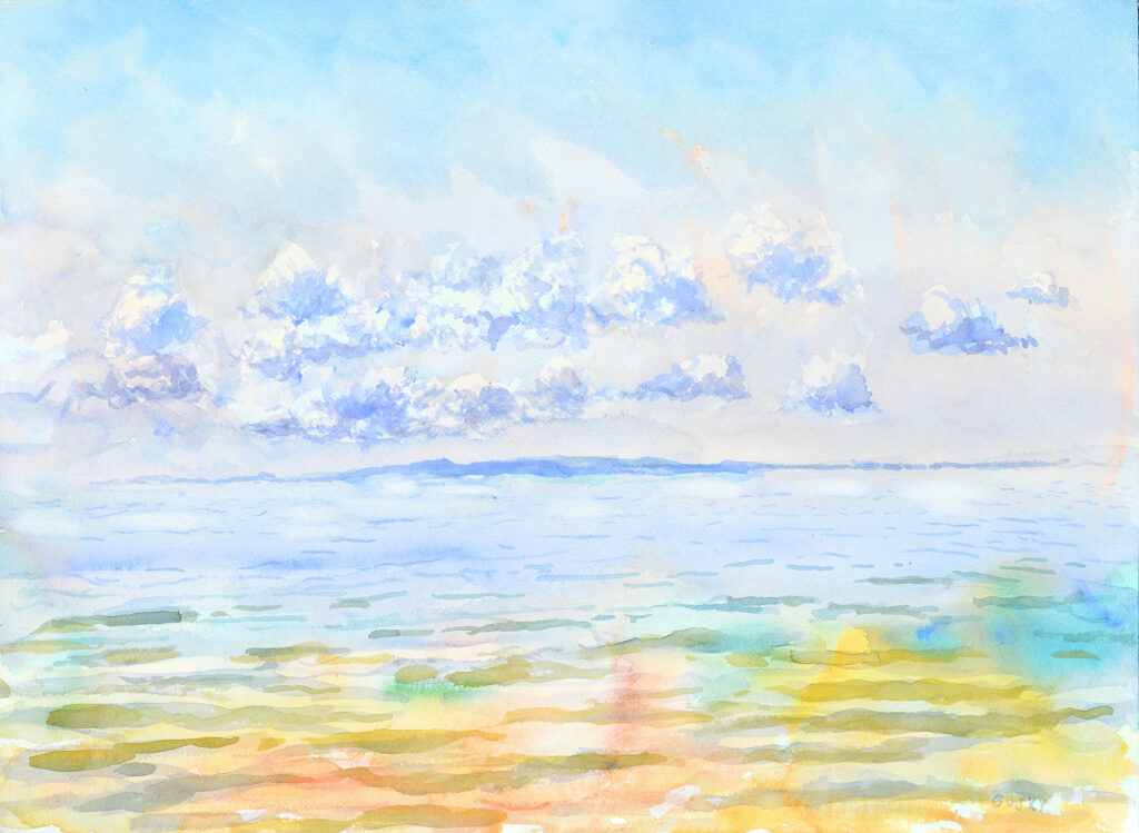 Brilliant shining sky with rows of bright white clouds over a distant cobalt island in a glassy smooth sea